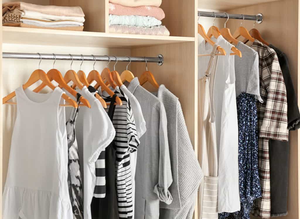 organizing clothes in a small closet